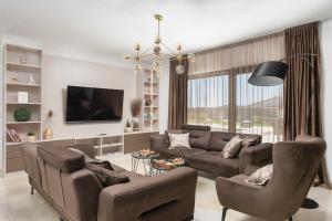a living room with a couch and chairs and a tv at Luxury Villa Heated Pool, 6 persons, Jacuzzi, Sea View in Zaglavice