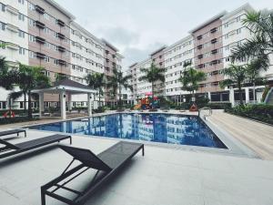 a swimming pool in front of a building at The Stars Lil' Suite in Trece Martires