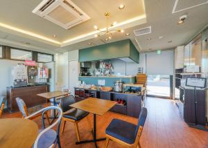 a restaurant with tables and chairs and a kitchen at Tabist TOKYO CITY VIEW HOTEL in Tokyo
