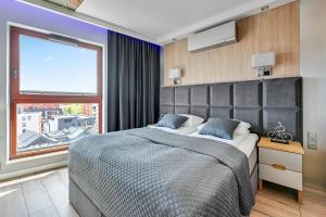 Ένα ή περισσότερα κρεβάτια σε δωμάτιο στο Elegant and Comfortable Apartments in Gdansk Dom & House