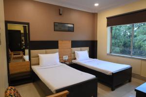 Postel nebo postele na pokoji v ubytování The Citi Residenci Hotel, Bidhannagar + 37 fotografií