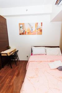 a bedroom with a bed and a desk in it at Witty Weekend retreat Quirk Cozy in Manila +155 photos