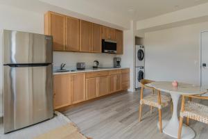 a kitchen with a stainless steel refrigerator and a table at Blueground Berkeley AC wd nr UC Theatre SFO-1814 in San Francisco