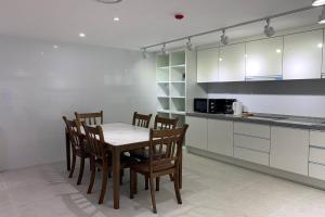 a kitchen with a table and chairs in a room at Hotel Kaya Puerto Galera in Sabang