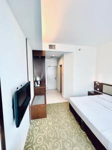 Postel nebo postele na pokoji v ubytování Seemsoon Hotel
