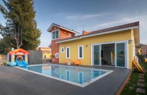 a house with a swimming pool in front of a house at Casa Ricca Pool Villa Khaoyai in Ban Pang Asok