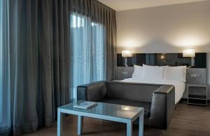A bed or beds in a room at AC Hotel Atocha by Marriott