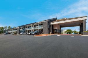 a large building with cars parked in a parking lot at Quality Inn Fort Jackson in Columbia
