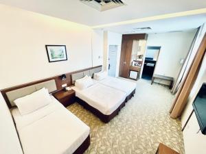 Postel nebo postele na pokoji v ubytování Seemsoon Hotel