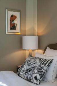 a bedroom with a bed with a pillow and a lamp at Hotel Taschenbergpalais Kempinski in Dresden