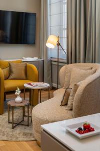 a living room with a couch and a table at Hotel Taschenbergpalais Kempinski in Dresden