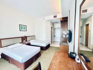 Postel nebo postele na pokoji v ubytování Seemsoon Hotel
