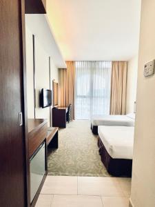 Postel nebo postele na pokoji v ubytování Seemsoon Hotel