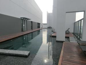 a swimming pool in the middle of a building at The Harmony Suite Hub SS2 in Petaling Jaya