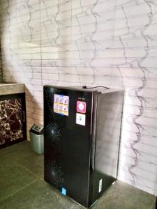 a black refrigerator in a room with a wall at Pondok D Angga Tampaksiring in Tegalalang +17 photos