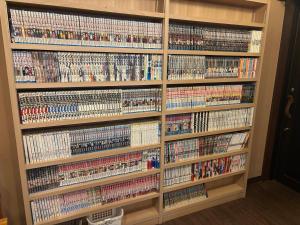 a book shelf filled with lots of video games at Dormy Inn Premium Hakata Canal City Mae in Fukuoka