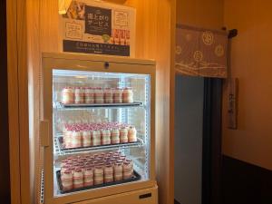 an open refrigerator filled with lots of food at Dormy Inn Premium Hakata Canal City Mae in Fukuoka