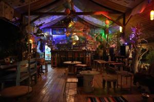 a bar with tables and chairs in a room at Seree Bungalows & Chill Bar in Ko Chang