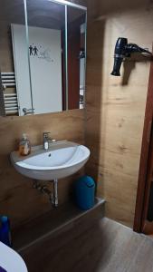 a bathroom with a white sink and a mirror at Meerblick in Glücksburg +17 photos