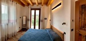 A bed or beds in a room at Agriturismo Tamellini