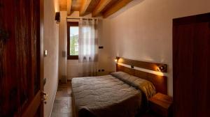 A bed or beds in a room at Agriturismo Tamellini