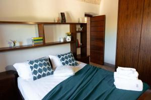 a bedroom with a bed with pillows on it at Tenuta Ulivi in Putignano
