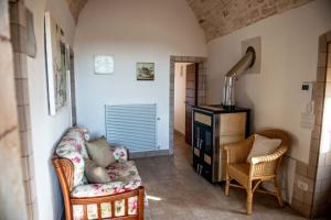 a living room with two chairs and a table at Tenuta Ulivi in Putignano
