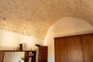 a room with a brick ceiling and a wooden door at Tenuta Ulivi in Putignano +31 photos