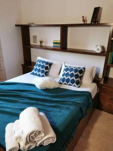 a bedroom with a bed with blue and white pillows at Tenuta Ulivi in Putignano