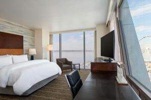 a hotel room with a large bed and a large window at The Westin Washington National Harbor in National Harbor