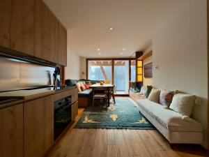 a living room with a couch and a table in it at Your Nest In The Mountains in Breuil-Cervinia