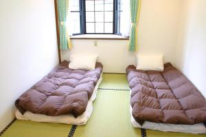 Postel nebo postele na pokoji v ubytování 916旅の宿