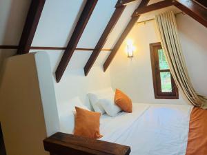 a bedroom with a bed in a room with a window at The Hideaway Sigiriya in Sigiriya