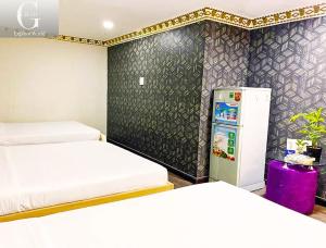 Postel nebo postele na pokoji v ubytování Crowne Hotel Bui Vien