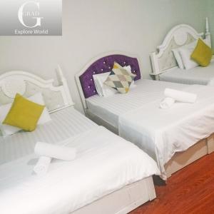 Postel nebo postele na pokoji v ubytování Crowne Hotel Bui Vien