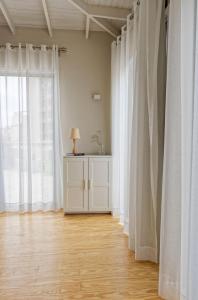 a room with white curtains and a table with a lamp at VESTA - Heliopolis Residence in Cairo +15 photos