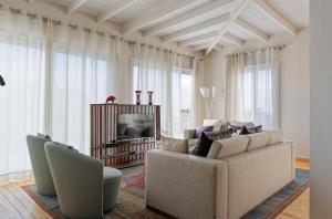 a living room with a couch and a television at VESTA - Heliopolis Residence in Cairo