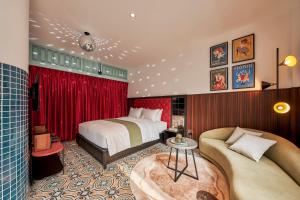 a hotel room with a bed and a couch at Dakao Vibe Studios by CIRCADIAN in Ho Chi Minh City