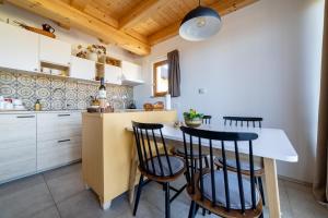 a kitchen with a table and four chairs at BEe in foREST in Pivka