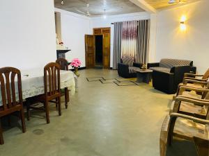 a living room with a table and chairs at Wakishta Villa - Weligama in Weligama