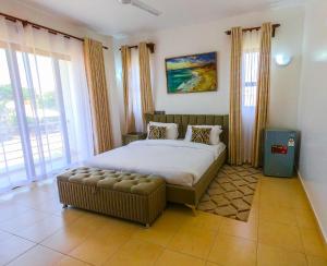 a bedroom with a large bed and a large window at Lux Suites Vipingo Luxury Villas in Kilifi +58 photos