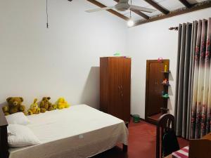 a bedroom with a bed with teddy bears on it at Wakishta Villa - Weligama in Weligama