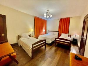 a hotel room with two beds and a window at FAMILY Guest house in Newark