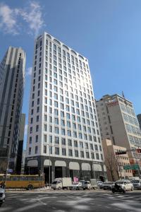 a large white building with cars parked in front of it at Namsan Dream City in Seoul