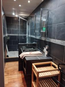 a bathroom with a shower and a sink and a tub at La maison de Marie, cosy et spacieuse - 3 chambres dont une climatisée in Châtillon-sur-Chalaronne +18 photos