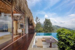 a villa with a swimming pool and a patio at 98 Acres Resort & Spa in Ella