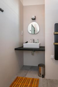 a bathroom with a sink and a mirror at KOREK Mikulov apartmán in Mikulov +24 photos