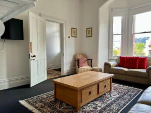 a living room with a couch and a coffee table at Charming Heritage Home in Launceston
