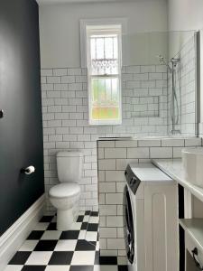a bathroom with a toilet and a sink at Charming Heritage Home in Launceston