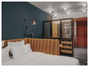 a bedroom with a white bed and a blue wall at 1.75 Paris Le Charme in Paris +6 photos